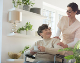 caregiver looking at the elderly while smiling